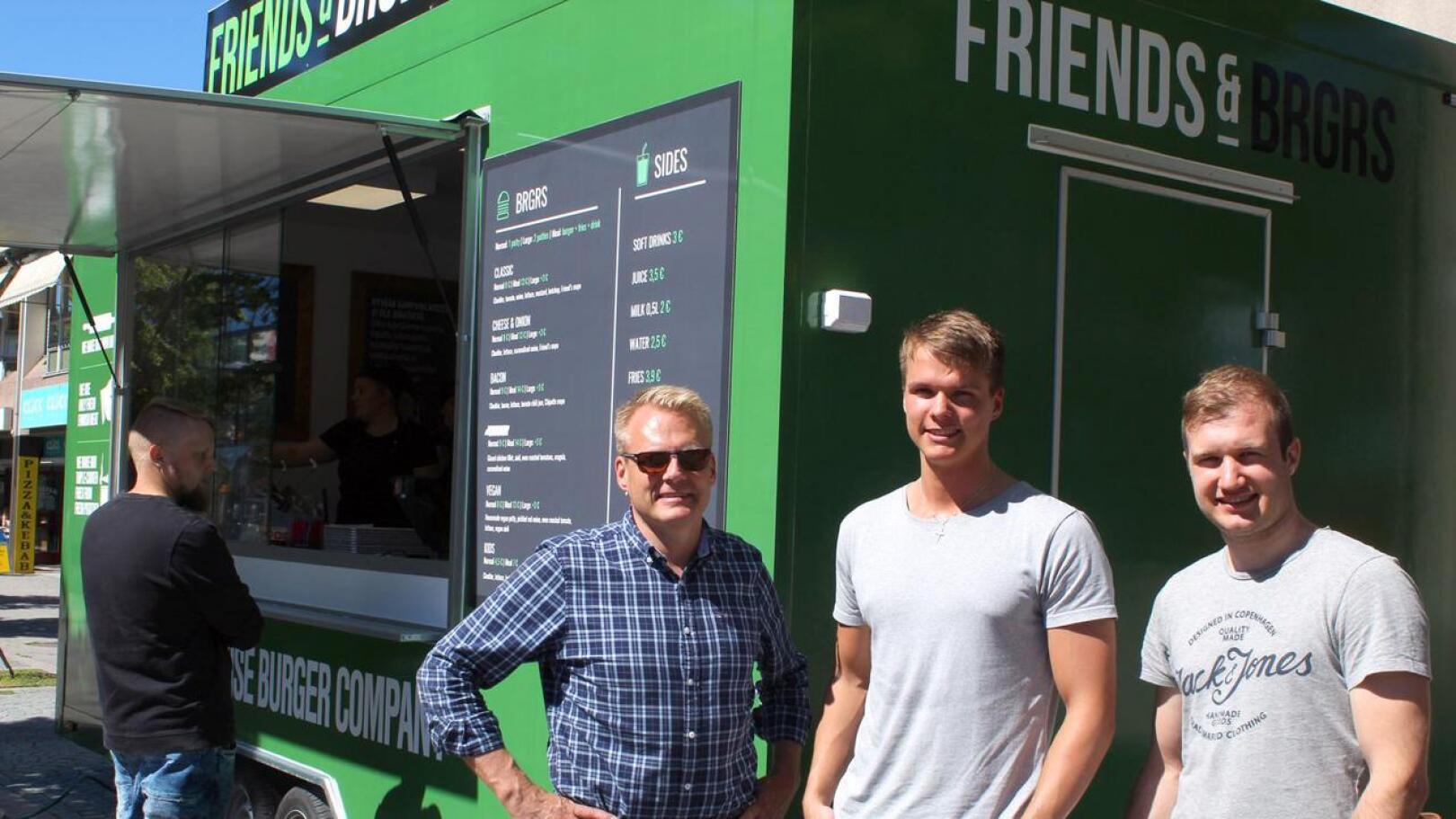 Friends & Brgrs:n talousjohtaja Kaj Fagerholm (vas.) sekä työntekijät Isak Fagerholm ja Andreas Byggmästar Kokkolan  myyntikojun edessä kesällä.