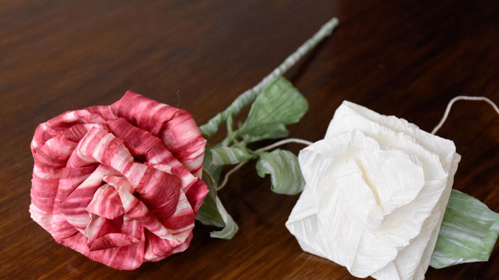Vasemmalla  yksittäisistä terälehdistä tehty paperiruusu ja oikealla taiteltu ruusu.