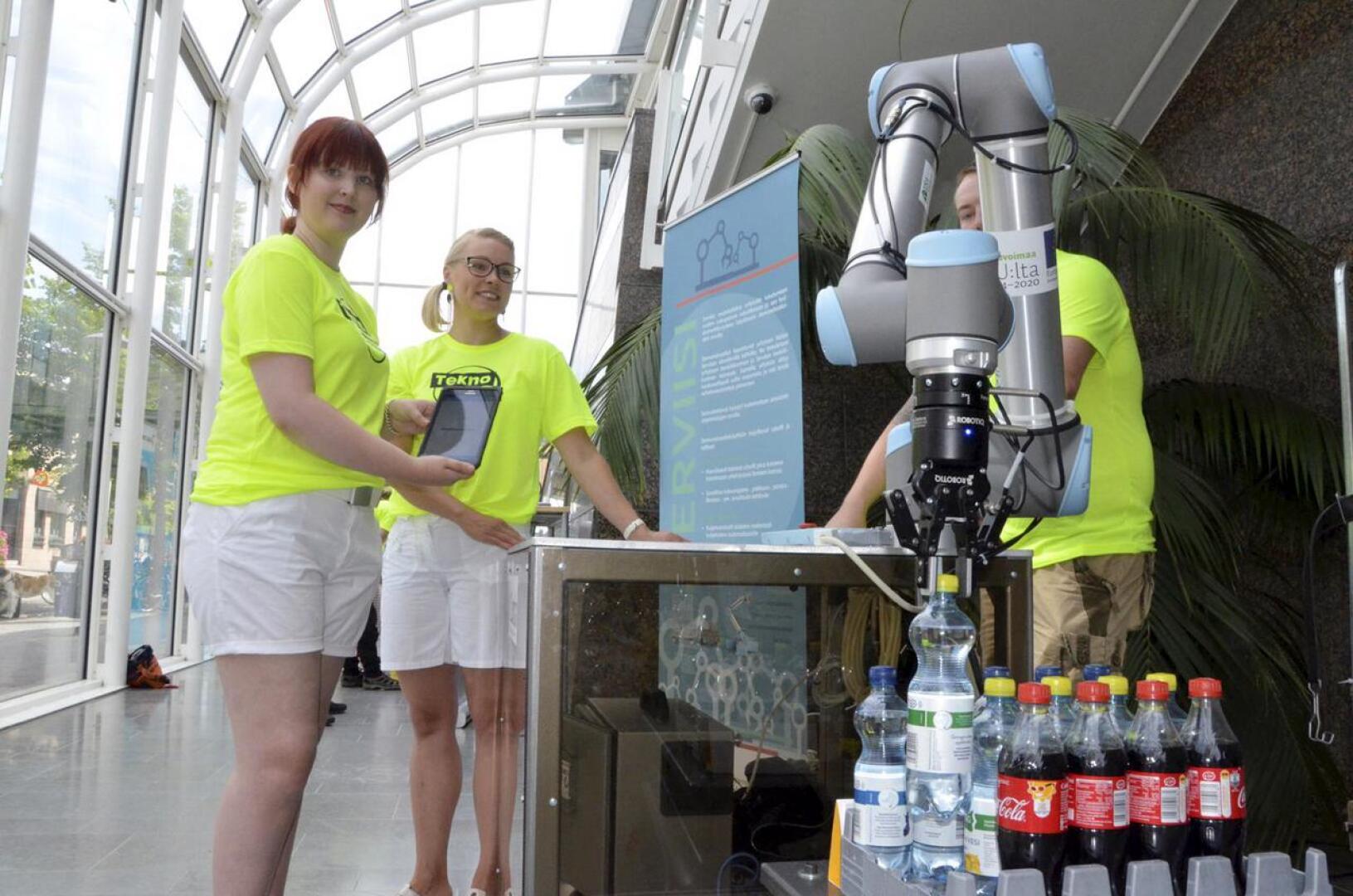 Tablettia klikkaamalla robotti tarjoili tapahtumakoordinaattori Leena Toivaselle ja Hanna Lahnalammelle virvoitusjuoman.